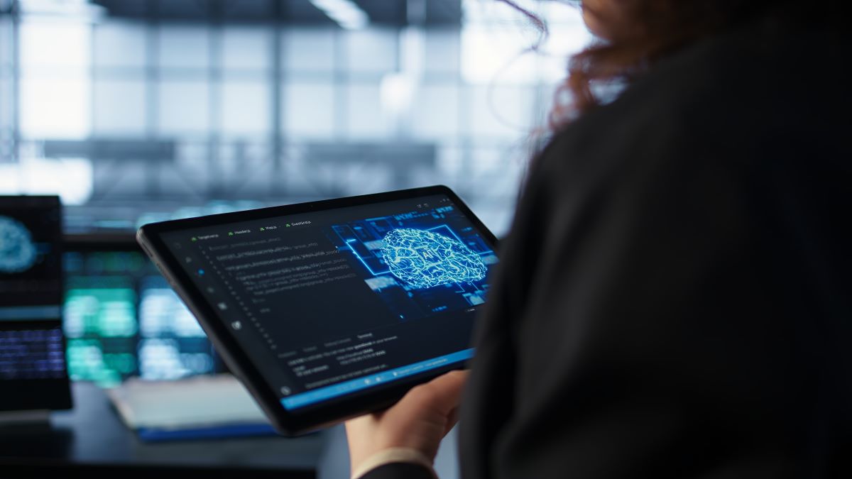 Data center technician using artificial intelligence tablet close up