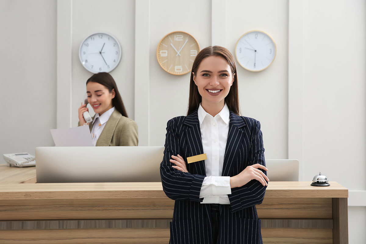 Portrait beautiful receptionist near counter hotel